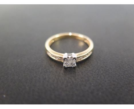 An 18ct yellow gold diamond ring set with four small square cut diamonds centrally in an open setting and a further six small