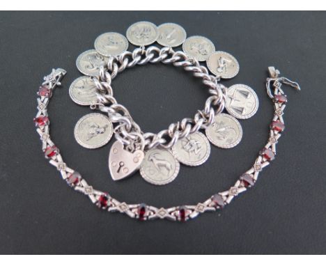 A silver curb-link bracelet - Suspending a series of charms depicting the signs of the zodiac - Hallmarked London - Length ap