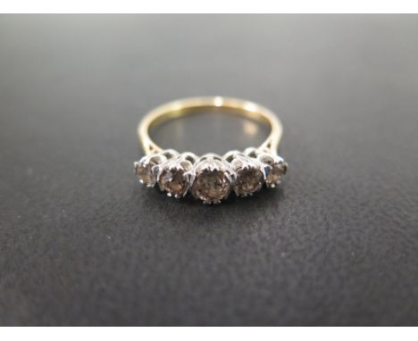 A 18 ct yellow gold and diamond ring set with five round cut diamonds in platinum claw settings, central stone approx. 0.22 c