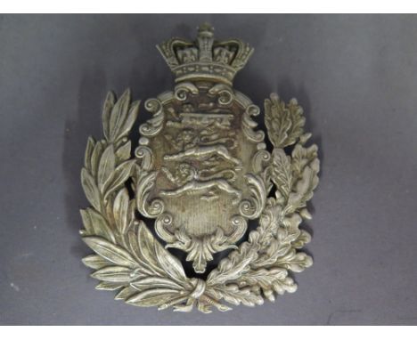 A Helmet badge with a coat of arms to the centre - 122 mm x 97 mm with two lugs on the back