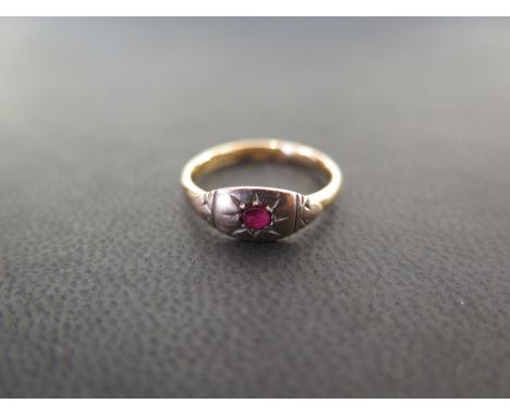 An early 20th century 18ct gold ruby band ring - Ring size J - Weight approx 2.3gms
Condition Report: Good to fair - With lig