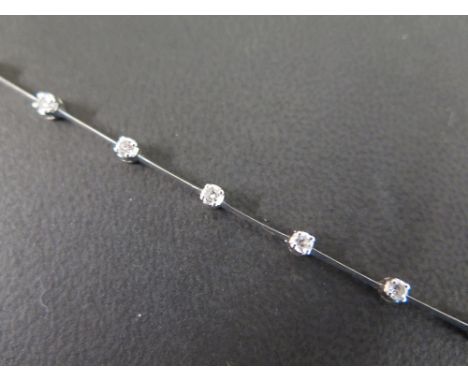 A modern 18 ct white gold diamond set bracelet set with fourteen diamonds in open claw setting with platinum bars between and