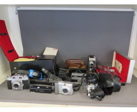 A collection of cameras and accessories  - including Olympus auto eye, boxed Minolta 16 MG-S, Cannon digital camera and a box