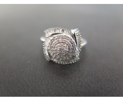 A 9 ct white gold and diamond ring set in a modern rosette setting with brilliant cut and baguette diamonds - size N 1/2