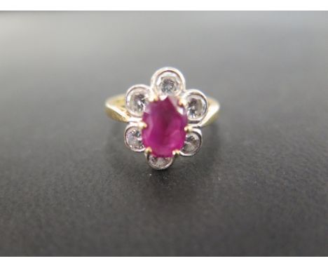 An 18ct gold ruby and diamond floral cluster ring - Estimated total diamond weight 1ct - Hallmarked Birmingham - Ring size L 