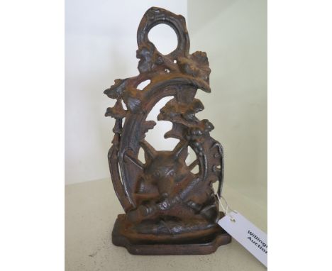 A Victorian cast iron door stop depicting Fox's head, Huntsman's whip etc.