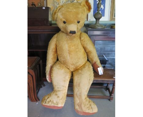A large vintage mohair teddy bear 1.4m tall
Condition report: Some fur loss to legs and head but generally sound