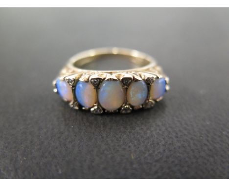 A pretty Victorian style 9 ct ring set with five oval opals with floral chase mount - Ring size O - Weight approx. 5.5 grms  