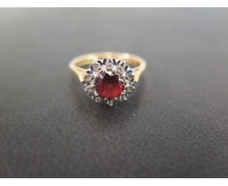 An 18ct gold garnet and diamond cluster ring - Hallmarked Birmingham - Ring size O - Weight approx 4.6grams Condition Report: