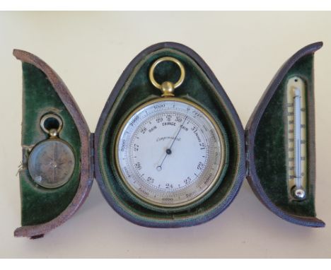 A pocket compensated Barometer in gilt metal case with fixed weather scale, altitude scale graduated  0 - 1000 feet, fixed we