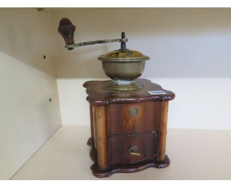 A late 19th century walnut veneered and brass coffee grinder, serpentine form
Condition report: Some old worm damage and vene