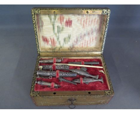 A French leather bound sewing box - the silk lined interior with removable board fitted with various silver accoutrements inc