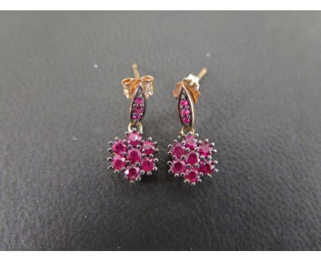 A pair of 9 ct gold ruby cluster drop earrings set with seven stones in each cluster and three in the drops - hallmark to pos