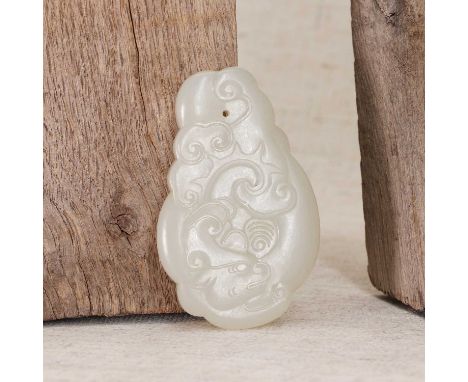 A Chinese jade pendant,19th-20th century, of a carp turning into a dragon among ruyi-shaped clouds, the stone of greyish-whit
