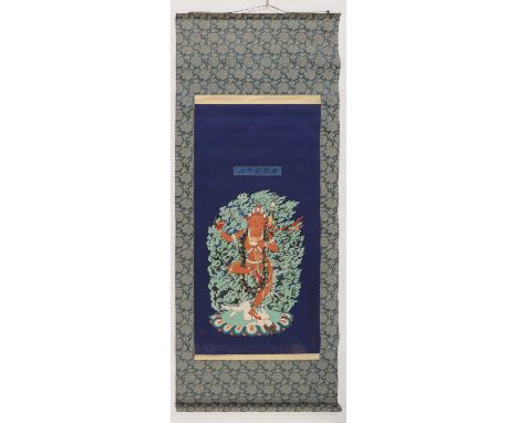 A Chinese hanging scroll,20th century, of a bodhisattva standing on a lotus flower in front of a flame-shaped mandorla, with 