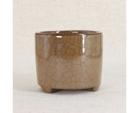 A Chinese ge-type glazed incense burner,mid-Qing dynasty, of cylindrical form on three bracket feet, covered under a thick cr
