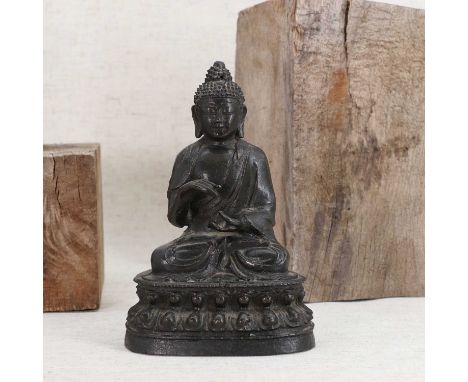 A Chinese bronze Shakyamuni Buddha,Ming Dynasty (1368-1644), wearing a long robe, seated cross-legged on a double lotus pedes