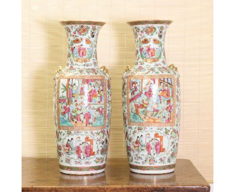 A pair of Chinese Canton famille rose vases,late 19th century, each of rouleau form flanked by two mask and ring handles, pai