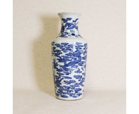 A Chinese blue and white vase, 18th century, of rouleau form, painted with dragons chasing flaming pearls among clouds, 42cm 