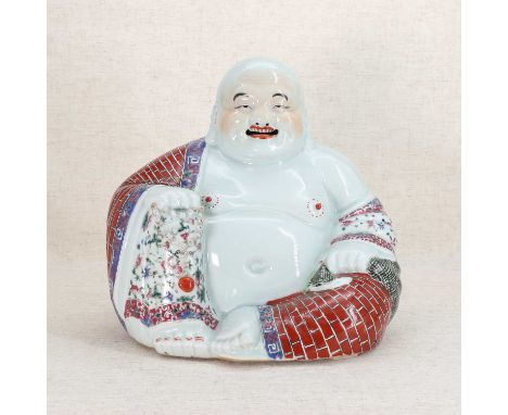 A Chinese famille rose Budai,20th century, wearing a garment painted with brickwork and florets with scroll borders, his righ