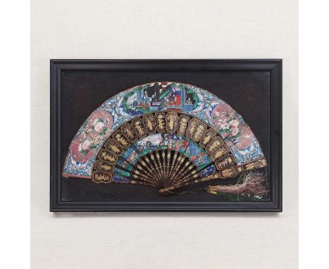 A Chinese Canton brisé fan,19th century, the splines gilt on a black ground, decorated with figures in a garden within a shap