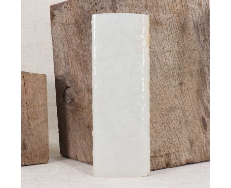 A Chinese white jade armrest,19th-20th century, in the shape of a scroll, carved with a chilong among clouds, the reverse ins