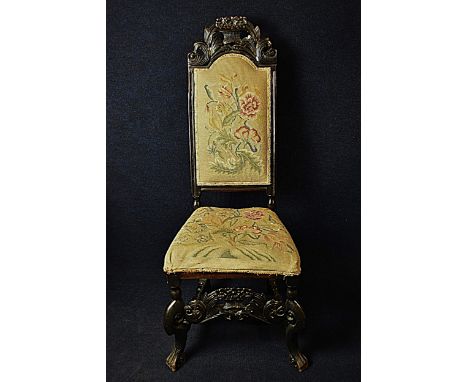 A 19th century oak Carolean style hall chair in tapestry upholstery. H.127cm 