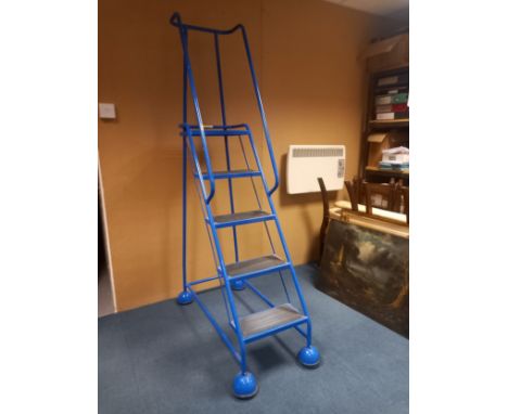 A Steptek narrow safety warehouse or library ladder with five steps on multidirectional casters. H. 194cm W. 43cm 