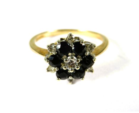 9ct Yellow Gold Ring set with a small central Diamond with Sapphires and Diamonds in a flower pattern .  Finger size 'K-5'   