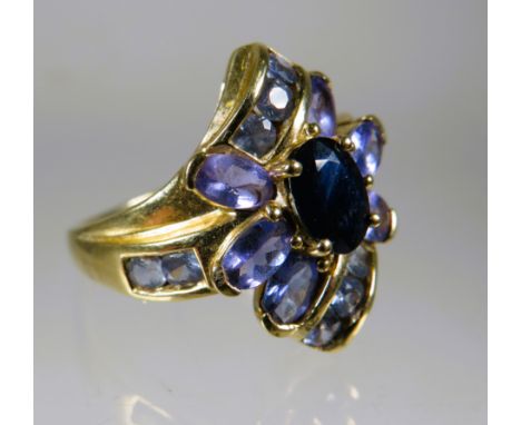 9ct Yellow Gold Ring set with Purple Gemstones in a flower pattern.  Finger size 'O-5 to P'     4.5g