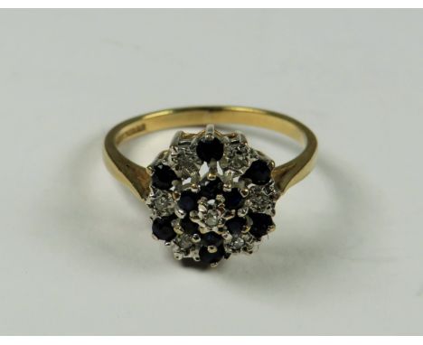 9ct Yellow Gold Diamond as Sapphire ring set in a Flower pattern.   Finger size 'M-5'   2.4g