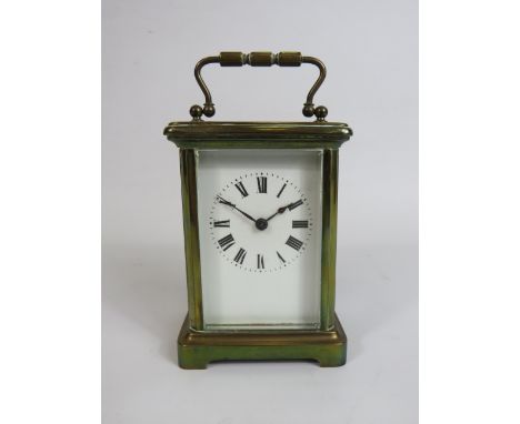 Pretty Brass Cased Carriage Clock with Key, enamel face. Running order 4.5 inches tall. ( door opens but needs attention to b