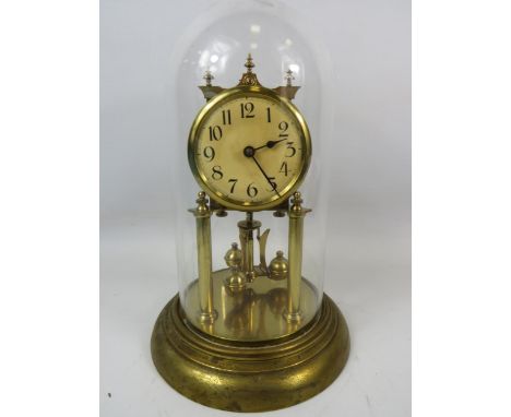 German Made Brass based Anniversary clock with enamel Dial. Sits under a Glass dome which measures approx 12 inches tall.  Ru
