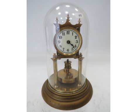 German Made Brass based Anniversary clock with enamel Dial. Sits under a Glass dome which measures approx 12 inches tall.  Ru
