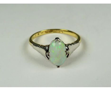 18ct Yellow Gold ring set with a lovely Oval Opal supported by Platinum shoulders.  Finger size 'P'   2.8