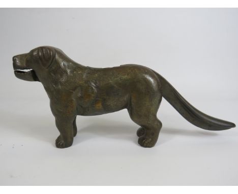 Cast brass nut cracker in the form of a dog , 31cm long and 13cm tall.