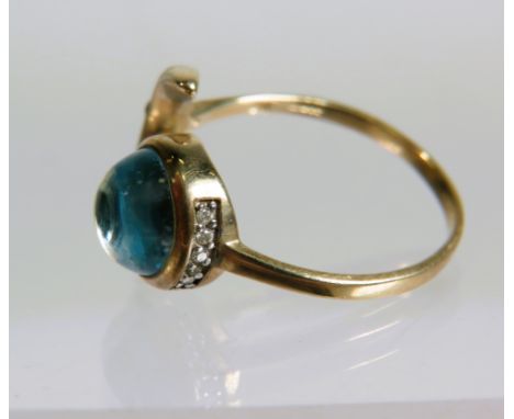 Unusual 9ct Yellow Gold Ring set with circular Aqua with Diamonds to moon segment and sides of Aqua Mount. Open spring mount 