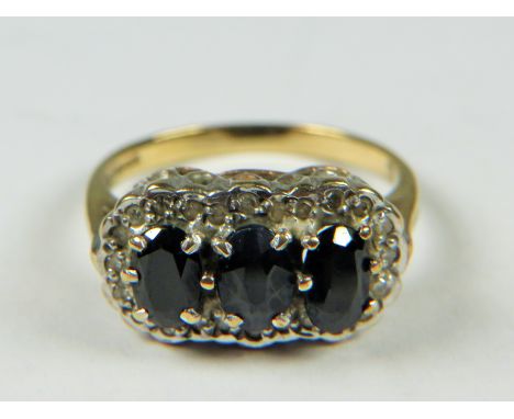 9ct Gold ring set with Triple Sapphires with Diamond surround.   Finger size 'L-5'  3.2g