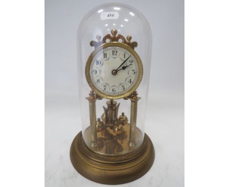 Brass Based Anniversary clock under a Glass Dome which measures approx 11 inches tall. Running order with no key. See photos.