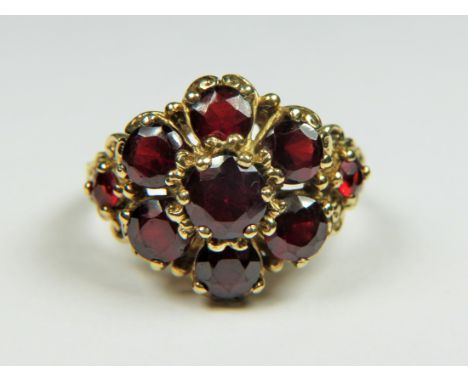 9ct Yellow Gold, Multi Garnet ring in a flower pattern. Finger size 'N'   6.1g
