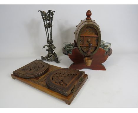 Vintage oak barrel liquor decanter, extending carved wood bookshelf and a epergne vase surround.