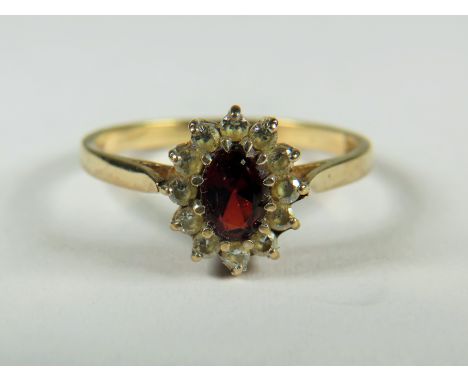 9ct Yellow Gold ring set with a Central Garnet with CZ Surround.   Finger size 'Q'  2.0g