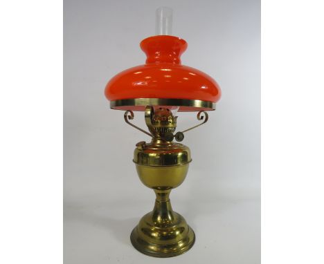 Duplex brass oil lamp with vibrate orange glass shade.