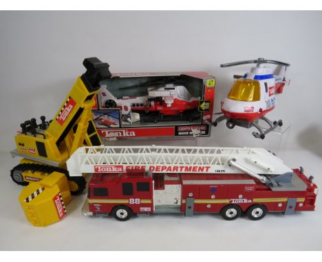 Various Tonka toys including a fire engine, helecopters, and crane.