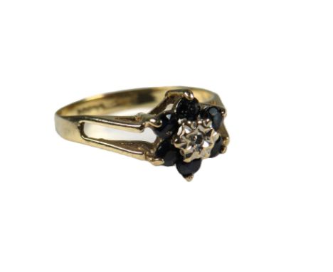 9ct Yellow Gold Ring set with a Central small Diamond surrounded by six sapphires. Finger size 'K' 1.1g