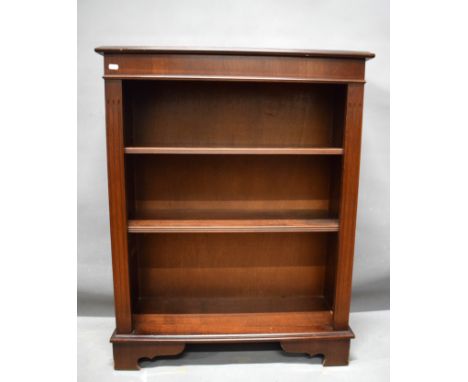 Darkwood bookshelf with lighter satinwood stringing decoration.   Raised on bracket feet it measures approx H:38 x W:30 x D:1