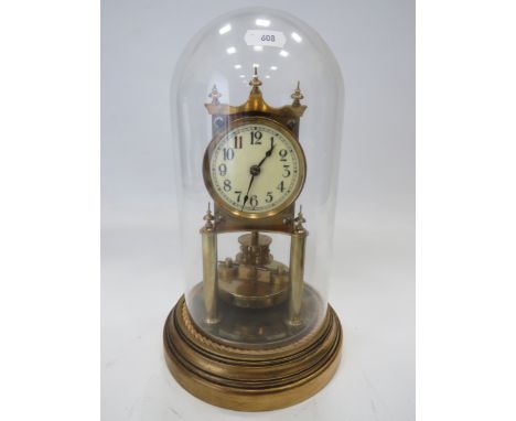 Gustav Becker Brass based Anniversary Clock under a Glass dome. Running order but no key present. Measures approx 12 inches t
