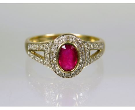 9ct Yellow Gold Ring set with a Central Oval Ruby with Diamonds to Shoulders.  Finger size 'P'    2.7g