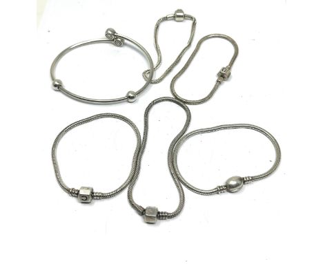 Six silver mixed brand charm bracelets (82g)