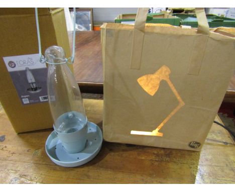 A brown paper bag lamp with image of angle poise lamp when lit and a Foras oil style light